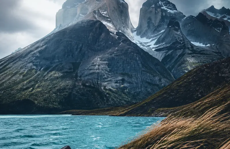 Jagged Patagonia peaks above a cold blue lake